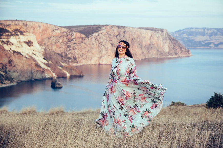 Plus-size-model-wearing-floral-maxi-dress-posing-in-field